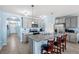 Modern kitchen with stainless steel appliances and island, view from dining area at 15502 Black Pepper Ln, Odessa, FL 33556