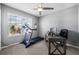 Home office with treadmill, desk, and window overlooking backyard at 15502 Black Pepper Ln, Odessa, FL 33556
