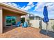 Covered patio with sliding glass doors leading to the home at 15502 Black Pepper Ln, Odessa, FL 33556