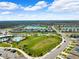 Aerial view of community with lake, homes, and green spaces at 15502 Black Pepper Ln, Odessa, FL 33556