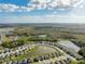 Aerial view of a residential area featuring a large lake and houses at 15502 Black Pepper Ln, Odessa, FL 33556