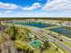 Aerial view of community with lake, homes, and recreational amenities at 15502 Black Pepper Ln, Odessa, FL 33556
