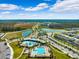 Aerial view of community pool, lake, and residential area at 15502 Black Pepper Ln, Odessa, FL 33556