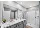Modern bathroom with double vanity and a large shower at 15502 Black Pepper Ln, Odessa, FL 33556