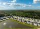Aerial view of a new residential community with houses and a lake at 15502 Black Pepper Ln, Odessa, FL 33556