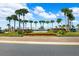 Entrance to The Preserve community, featuring palm trees and landscaping at 15502 Black Pepper Ln, Odessa, FL 33556