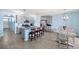 Modern kitchen with stainless steel appliances and island, view from hallway at 15502 Black Pepper Ln, Odessa, FL 33556