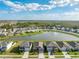 Community featuring a lake with fountain and numerous homes at 15502 Black Pepper Ln, Odessa, FL 33556