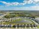Aerial view of a residential community with a lake at 15502 Black Pepper Ln, Odessa, FL 33556