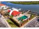 Aerial view of community pool, lounge area, and docks on the water at 19111 Vista Bay Dr # 201, Indian Shores, FL 33785