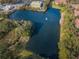 Beautiful aerial view of a pond with a fountain surrounded by lush greenery and buildings at 2690 Coral Landings Blvd # 722, Palm Harbor, FL 34684