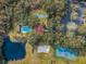 Aerial view of the property featuring pool, tennis court, and lake at 2690 Coral Landings Blvd # 722, Palm Harbor, FL 34684