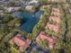 Aerial view of an apartment complex surrounded by mature trees and foliage at 2690 Coral Landings Blvd # 722, Palm Harbor, FL 34684