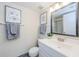 Well-lit bathroom featuring a white vanity, framed art, and decorative towels at 2690 Coral Landings Blvd # 722, Palm Harbor, FL 34684