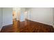 Bright bedroom featuring hardwood floors and a view into the bathroom at 2690 Coral Landings Blvd # 722, Palm Harbor, FL 34684