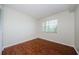 Bedroom featuring hardwood floors and a window with blinds at 2690 Coral Landings Blvd # 722, Palm Harbor, FL 34684
