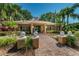 Charming clubhouse entrance with a brick walkway, landscaping, and American flag at 2690 Coral Landings Blvd # 722, Palm Harbor, FL 34684