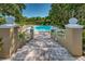 Inviting community pool with a staircase entry and manicured landscaping at 2690 Coral Landings Blvd # 722, Palm Harbor, FL 34684