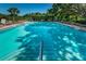 Sparkling community pool with ample lounge chairs for relaxing by the water at 2690 Coral Landings Blvd # 722, Palm Harbor, FL 34684