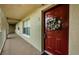 Exterior entryway with a red front door decorated with a wreath and a window to the side at 2690 Coral Landings Blvd # 722, Palm Harbor, FL 34684