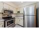 Kitchen featuring stainless steel appliances and ample storage space at 2690 Coral Landings Blvd # 722, Palm Harbor, FL 34684