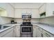 Updated kitchen featuring stainless appliances and bright countertops at 2690 Coral Landings Blvd # 722, Palm Harbor, FL 34684