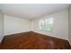 Bright living room with laminate floors, a window offering natural light, and a door leading outside at 2690 Coral Landings Blvd # 722, Palm Harbor, FL 34684