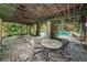 Charming patio by the pool area featuring a round table and chairs, perfect for outdoor gatherings at 2690 Coral Landings Blvd # 722, Palm Harbor, FL 34684