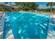 Sparkling community pool with ample lounge seating and well-maintained landscaping, perfect for summer relaxation at 2690 Coral Landings Blvd # 722, Palm Harbor, FL 34684