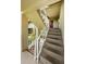 View of condo staircase leading to a front door adorned with a wreath, providing an inviting entrance at 2690 Coral Landings Blvd # 722, Palm Harbor, FL 34684