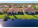 Aerial view of the home and surrounding community nestled on a scenic lake at 4847 Marble Springs Cir, Wimauma, FL 33598