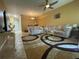Spacious living room with neutral decor, ceiling fan, and ample natural light at 6007 Skydale Way # 201, Riverview, FL 33578