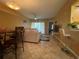 Open living room features tile floors, a ceiling fan, and access to a patio at 6007 Skydale Way # 201, Riverview, FL 33578