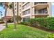 Well-maintained building exterior with lush landscaping at 700 Island Way # 106, Clearwater Beach, FL 33767
