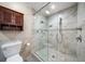 Elegant bathroom features glass walk-in shower, cabinet, and tile flooring at 700 Island Way # 106, Clearwater Beach, FL 33767