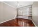 Bright bedroom features hardwood floors, white shutters, and built-in shelves and bench seating at 700 Island Way # 106, Clearwater Beach, FL 33767