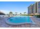 Resort-style swimming pool with a beautiful view and lounge chairs at 700 Island Way # 106, Clearwater Beach, FL 33767