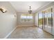 Dining room with tile floors and sliding glass doors to balcony at 700 Island Way # 106, Clearwater Beach, FL 33767