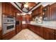 Gourmet kitchen showcases rich wood cabinetry, stainless steel appliances, tile flooring, and an island countertop at 700 Island Way # 106, Clearwater Beach, FL 33767