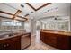 Open kitchen features granite countertops, wood cabinets, stainless steel appliances, and tiled flooring at 700 Island Way # 106, Clearwater Beach, FL 33767
