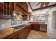 Bright kitchen boasts granite countertops, stainless appliances, wood cabinets, and tile backsplash and floors at 700 Island Way # 106, Clearwater Beach, FL 33767