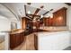 Spacious kitchen features wood cabinets, granite countertops, tile floors, and modern stainless steel appliances at 700 Island Way # 106, Clearwater Beach, FL 33767