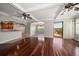 Spacious living room with hardwood floors that transitions into the adjacent dining room at 700 Island Way # 106, Clearwater Beach, FL 33767