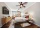Comfortable main bedroom with hardwood floors, ceiling fan, and natural light from large window at 700 Island Way # 106, Clearwater Beach, FL 33767