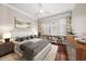 Bright bedroom with hardwood floors, built-in shelves, and a large window at 700 Island Way # 106, Clearwater Beach, FL 33767