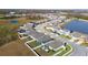 Aerial view of a residential neighborhood with houses and a lake at 8852 Prairie Creek Dr, New Port Richey, FL 34655