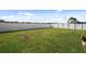 Large grassy backyard with a white vinyl fence at 8852 Prairie Creek Dr, New Port Richey, FL 34655