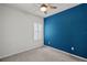 Bedroom with blue accent wall, ceiling fan and window with shutters at 8852 Prairie Creek Dr, New Port Richey, FL 34655