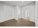 Bright entryway with wood-look floors and doors leading to other rooms at 8852 Prairie Creek Dr, New Port Richey, FL 34655