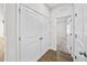 Hallway with double doors and wood-look floors at 8852 Prairie Creek Dr, New Port Richey, FL 34655
